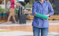 Injured woman with green cast on hand and arm on traveler in mot Royalty Free Stock Photo
