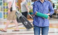 Injured woman with green cast on hand and arm on traveler in mot Royalty Free Stock Photo