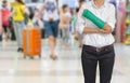 Injured woman with green cast on hand and arm on traveler in motion blur in airport interior background, ,body injury concept Royalty Free Stock Photo