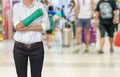 Injured woman with green cast on hand and arm on traveler in motion blur in airport interior background, ,body injury concept Royalty Free Stock Photo