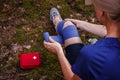 Injured woman using elastic bandage from first aid kit Royalty Free Stock Photo