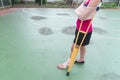 Injured woman wearing sportswear painful arm with gauze bandage, arm sling and wooden crutches on green floor Royalty Free Stock Photo