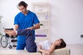 Injured woman visiting young male doctor osteopath