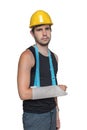 Injured worker is wearing medical sling on his arm. Isolated on white background