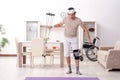 The injured young man doing exercises at home Royalty Free Stock Photo