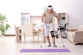 Injured young man doing exercises at home Royalty Free Stock Photo