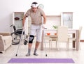 Injured young man doing exercises at home Royalty Free Stock Photo