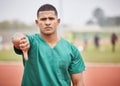 Injuries are not welcome here. Cropped portrait of a handsome young male paramedic giving thumbs down while standing on