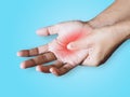 Injury with hand pain isolated on blue background with clipping path