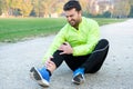 Male athlete suffering from pain in leg while exercising outdoor Royalty Free Stock Photo