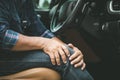 Man use hands hold and massage on his knee in the car while stop. Outdoor shooting for transport and healthcare Royalty Free Stock Photo