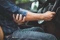 Injury or tired from long driving concept : Man use hands to hold and massage on his elbow in the car while stop Royalty Free Stock Photo