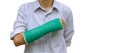 injury woman broken arm with green cast on arm standing on white Royalty Free Stock Photo