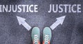 Injustice and justice as different choices in life - pictured as words Injustice, justice on a road to symbolize making decision