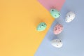 Modern Easter Holiday Composition with Eggs on a Pink-Yellow-Blue Geometric Background.