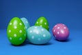 Beautiful hand-made colorful pastel easter eggs on deep blue background Royalty Free Stock Photo