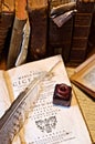 Ink and feather on old books and writing stuff Royalty Free Stock Photo