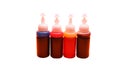 Ink for inkjet printer in bottles on white background. 4 basic colors - cyan blue, magenta, yellow, black