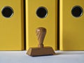 Ink stamp and yellow document folders. Royalty Free Stock Photo