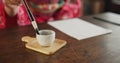 Ink, writing and hands of Japanese woman in home for traditional script on paper, documents and page. Creative, culture Royalty Free Stock Photo