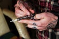 Inked hands of tattoing master