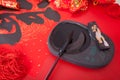 Inkstone and writing brush on red background.The Chinese characters on the spring couplets mean `happiness` Royalty Free Stock Photo