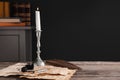 Inkwell, feather, fountain pen, candlestick and vintage parchment with ink stains on wooden table indoors. Space for text Royalty Free Stock Photo