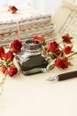 Inkwell, pen, dried roses and stack of vintage letters Royalty Free Stock Photo