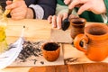 An inkwell with a white quill pen traditional handwritten accessories stand on a wooden table Royalty Free Stock Photo