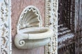 Inlaid marble holy water font outside an Italian Romanesque church - Santa Maria della Spina church (Italy-Pisa)