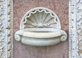 Inlaid marble holy water font outside an Italian Romanesque church - Santa Maria della Spina church (Italy-Pisa)