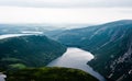 Inland fjord between steep cliffs against green landscape Royalty Free Stock Photo