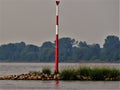 Inland shipping regulation red bar Blurred background with trees, river Rhein Germany