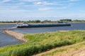 Inland tanker sailing upstream on river Waal, Netherlands