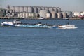 Inland tanker ship Colonia in the botlek port at chemical industries in the Botlek Harbor in Rotterdam with Vopak tanks