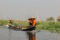 Inle Lake, Myanmar - January 26, 2020. Fisherman driving a small wooden boat. Calm afternoon on the boat exploring the floating