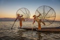 Burmese fishermen on bamboo boats at sunrise Royalty Free Stock Photo