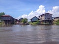 INLE LAKE, MYANMAR - MAY 26, 2014 : Local people are on longtail boat in front of Floating village at Inle Lake Royalty Free Stock Photo