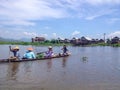 INLE LAKE, MYANMAR - MAY 26, 2014 : Local people are on longtail boat in front of Floating village at Inle Lake Royalty Free Stock Photo