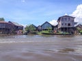 INLE LAKE, MYANMAR - MAY 26, 2014 : Local people are on longtail boat in front of Floating village at Inle Lake Royalty Free Stock Photo