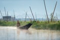 Inle / Myanmar - Jan 14, 2014 : Burmese woman paddling on a canoe in the morning canal