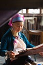 Inle, Myanmar - March 2019: Kayan Lahwi tribe long neck woman sits behind the loom