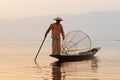 Inle, Myanmar - March 2019: Traditional Burmese leg rowing fisherman at Inle lake Royalty Free Stock Photo