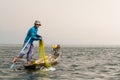 Inle, Myanmar - March 2019: Traditional Burmese leg rowing fisherman at Inle lake Royalty Free Stock Photo