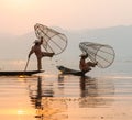 Inle, Myanmar - March 2019: two traditional Burmese leg rowing fishermen at Inle lake Royalty Free Stock Photo