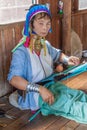 INLE, MYANMAR - NOVEMBER 28, 2016: Kayan long neck woman is weaving a fabric in a workshop at Inle lake, Myanm