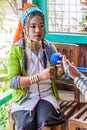 INLE, MYANMAR - NOVEMBER 28, 2016: Kayan long neck woman working in a fabric workshop at Inle lake, Myanm