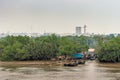 Inlet with slums and boat on Song Sai Gon River, Ho Chi Minh City, Vietnam