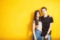 Inlove couple posing in fashion style on yellow wall