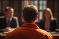 Inmate in Orange Jumpsuit Facing a Panel During a Parole Hearing or Trial Royalty Free Stock Photo